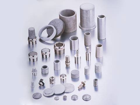 Several different sizes, shapes and specifications of stainless steel powder filter elements on gray background.