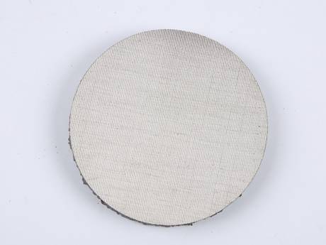 A round shape sintered filter disc with dutch weave woven wire reinforcement layer.